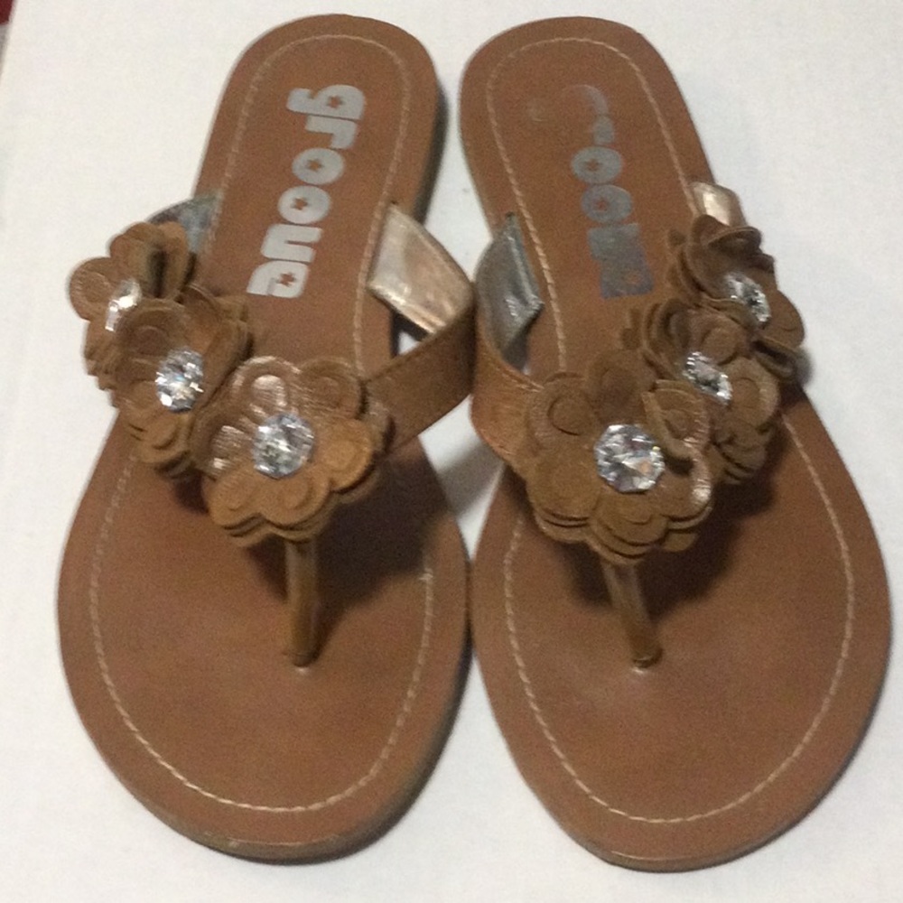 Grove Stylish flowered flip flops.